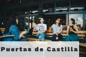 Four Women Chatting While Sitting on Bench