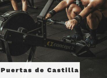 topless man using rowing machine