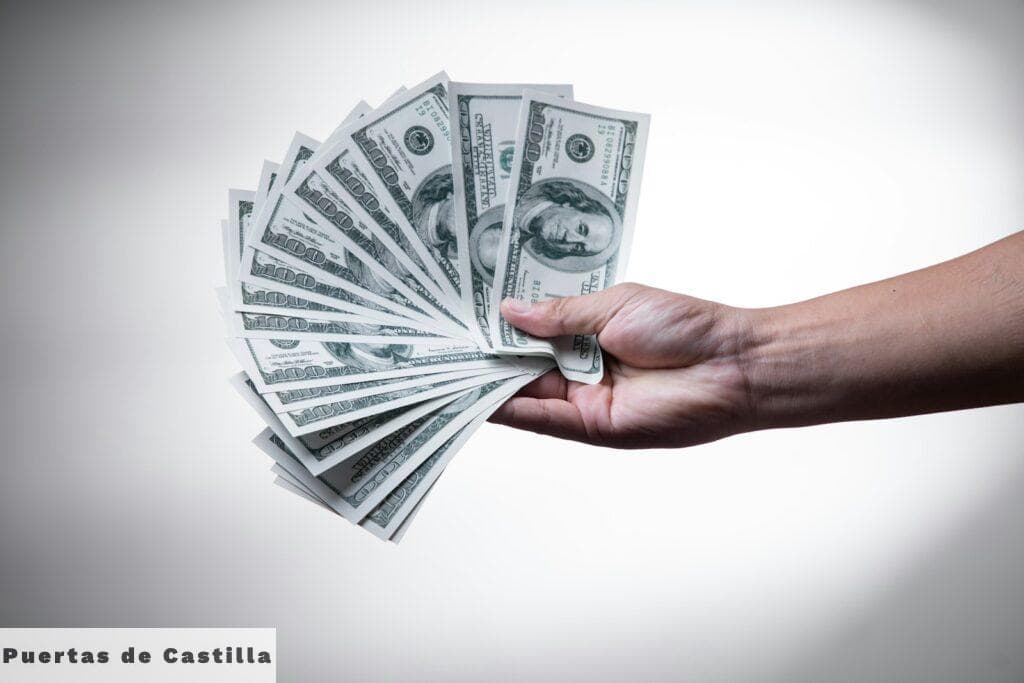 person holding 100 US Dollar banknote