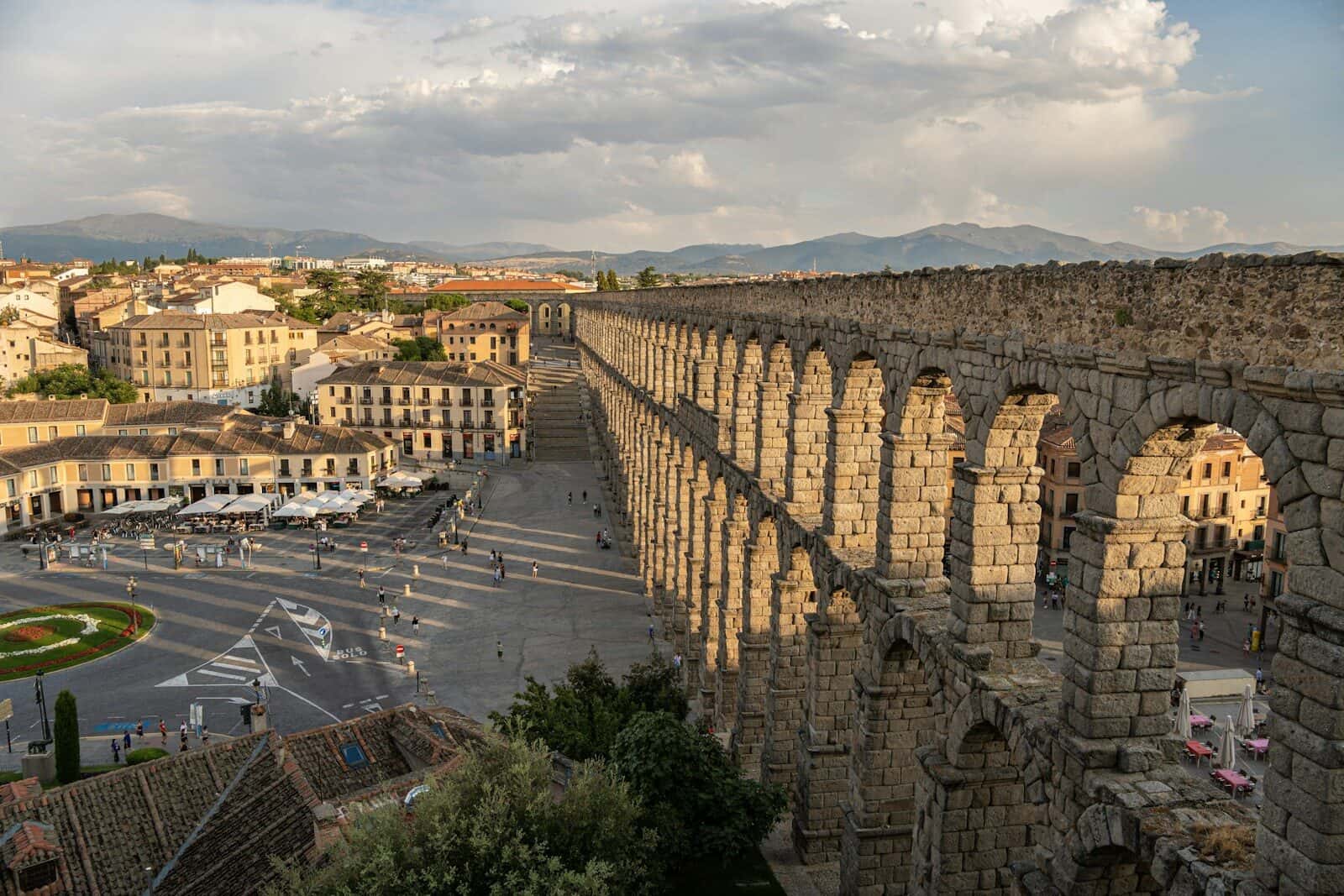 a large stone bridge over a parking lot